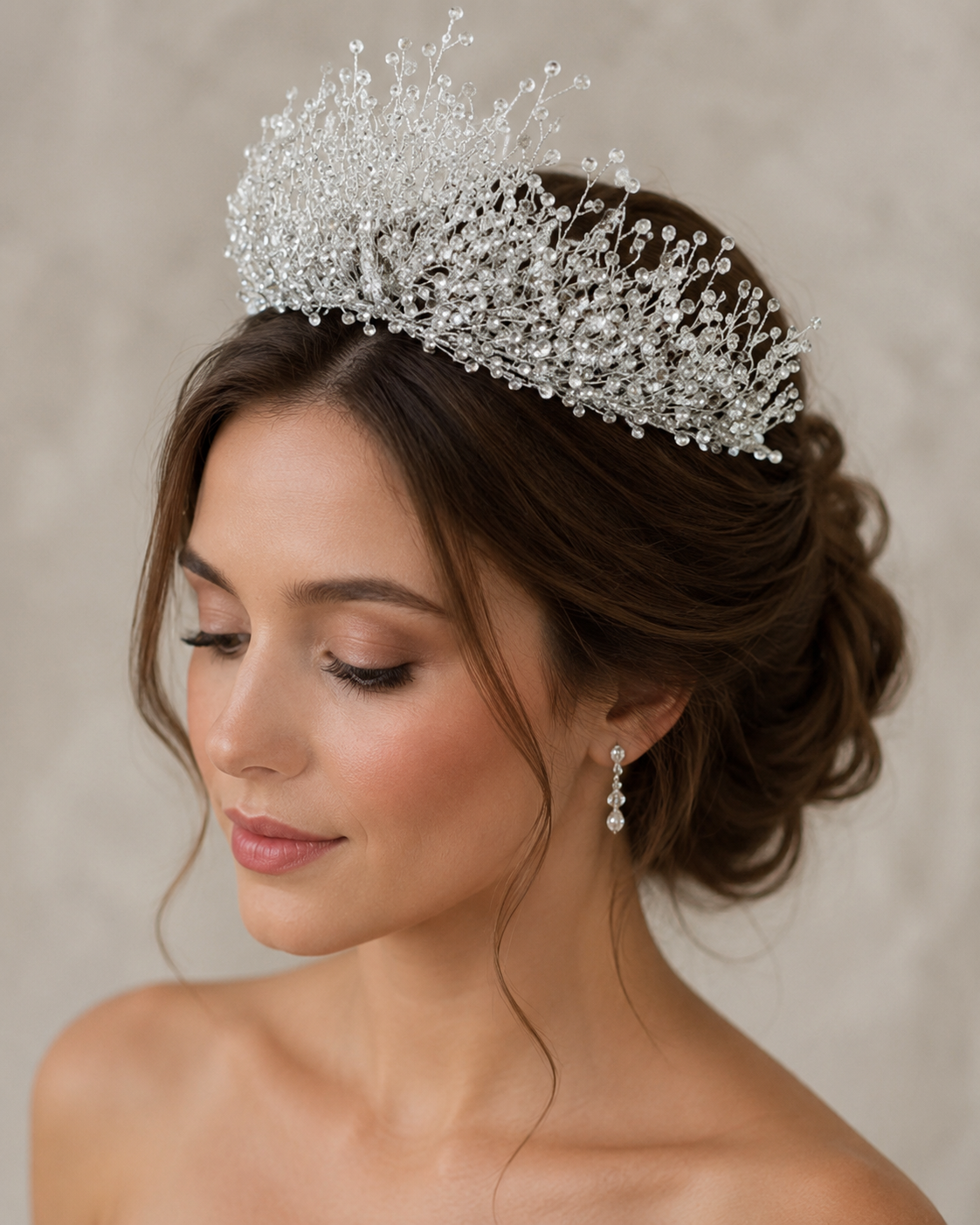 Woman wearing a sparkling tiara with a neutral background