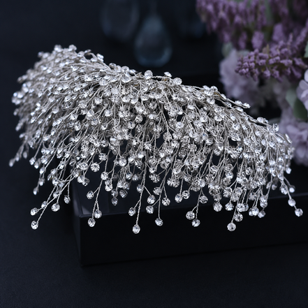Silver hairpiece with crystals on a black background